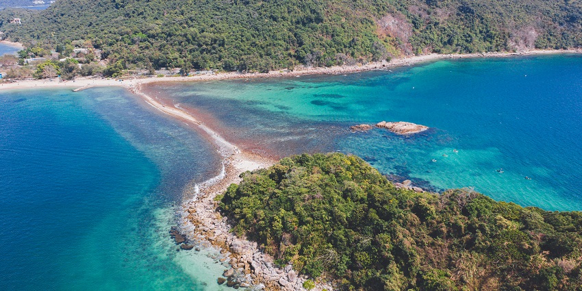 Aerial view of Sharp Island surrounded by blue waters and lush greenery in Hong Kong.