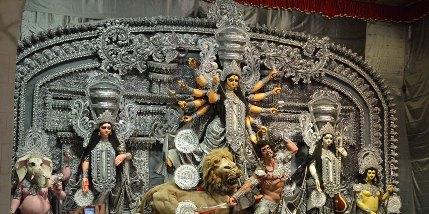 The silver Durga idol displayed at Sreebhumi pandal, richly decorated for Durga Puja in Kolkata, with gathered devotees.