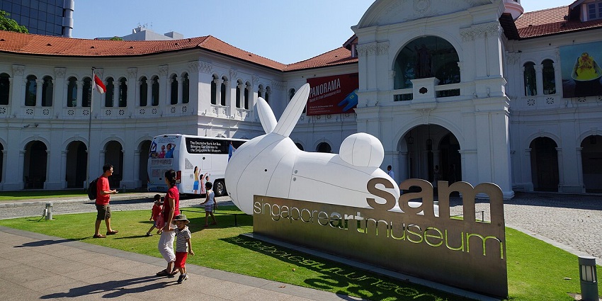 Singapore Art Museum with a white colonial façade and an outdoor SAM sculpture sign.