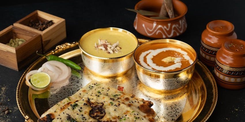 Traditional thali with Indian curry and naan at Socialite restaurant, one of the restaurants in city centre Guwahati.