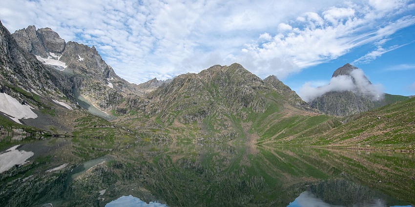 Still waters of the Vishansar Lake in Sonmarg Valley mirror the rocky hills surrounding it.