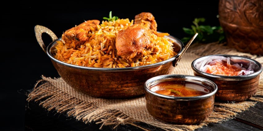 Flavourful chicken biryani served hot with red chutney at Spice Route restaurant.