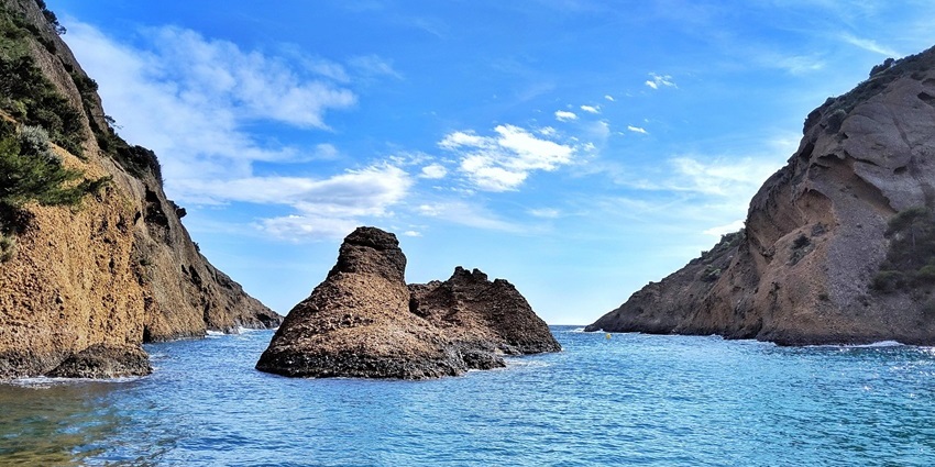 Scenic view of St. Estevam Island with lush greenery and riverbank, one of the top islands in Goa.