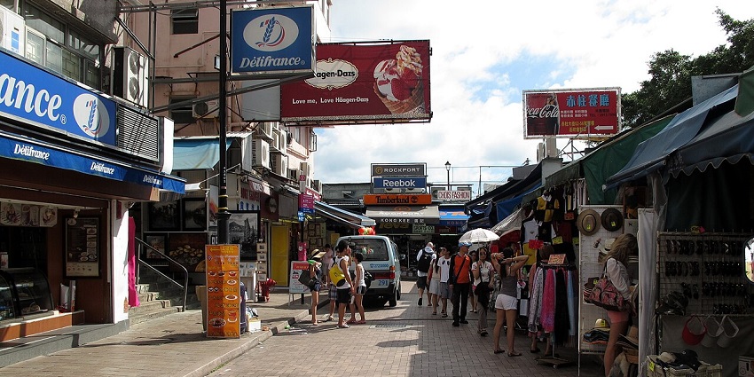 Crowds browsing stalls at Stanley Market, a popular shopping destination in Hong Kong.
