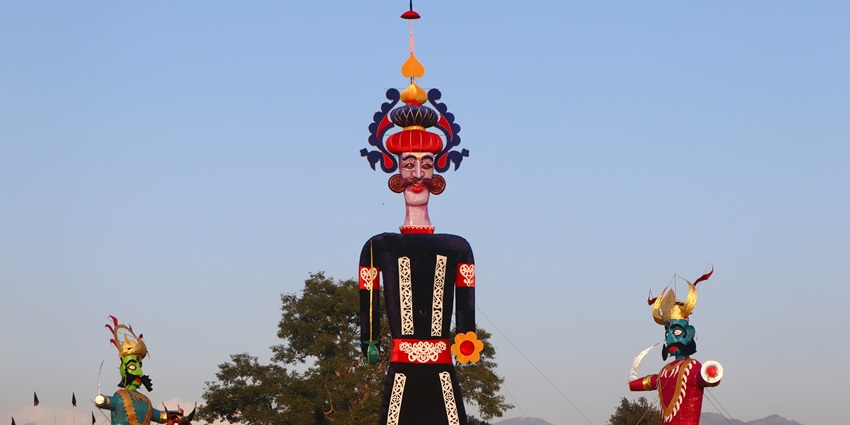 Colorfully painted Raavan effigy during dawn at Dussehra celebration in India.