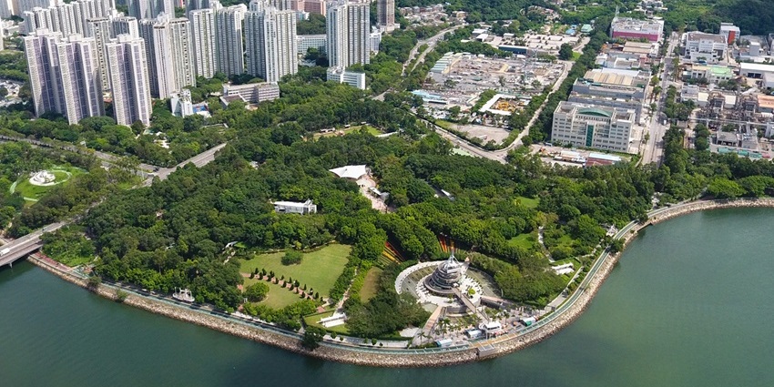 Aerial view of Tai Po Waterfront Park with promenade, lawns & lookout tower, one of the parks in Hong Kong.
