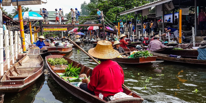 Traditional boats at Tha Kha, one of the authentic floating markets in Thailand.
