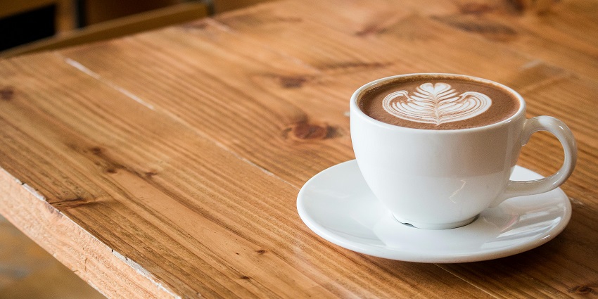 A close-up view of a cup of cappuccino is served with latte art at the Coffee Shop.
