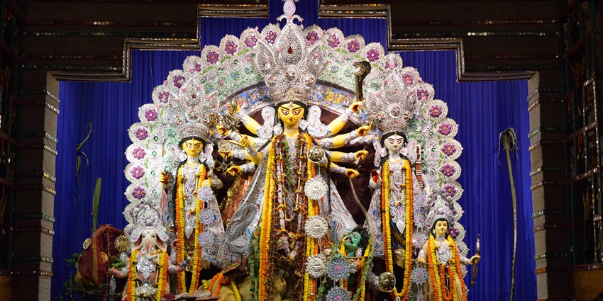 Intricately decorated pandal with Goddess Durga and her children during Durga Puja in Kolkata.