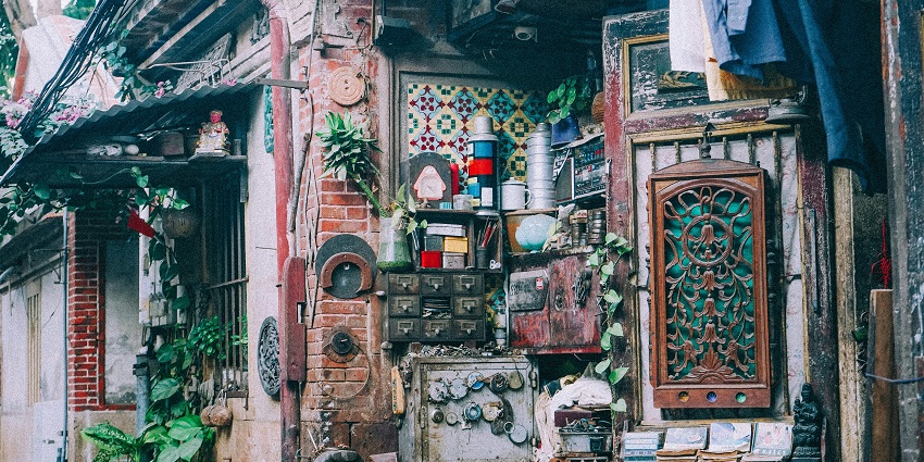 Vintage items and rustic furniture are arranged on display at The Sustainable City Flea Market.
