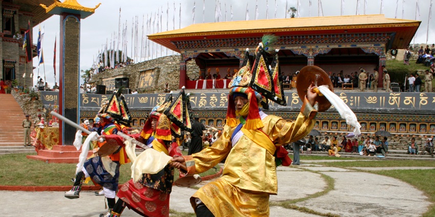 Buddhist monks dressed in traditional robes perform the Pangteod Chaam dance during Tihar.