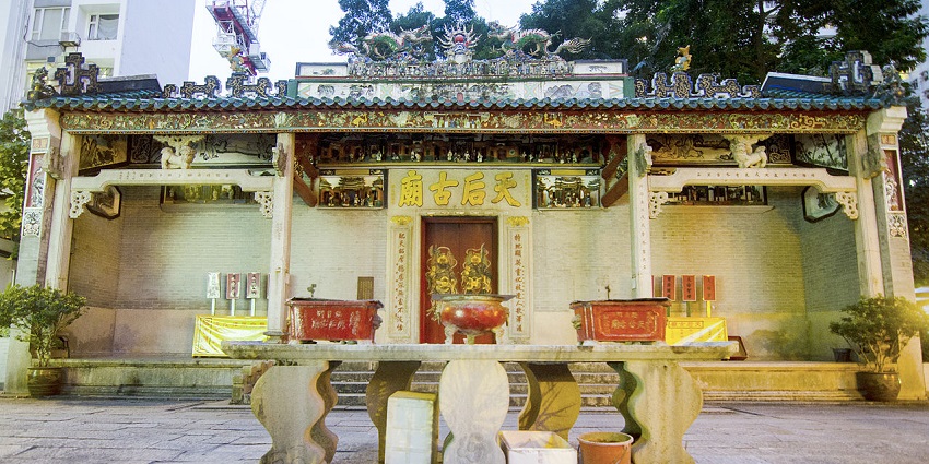 Tin Hau Temple at Causeway Bay has multiple signs and vibrant architecture.