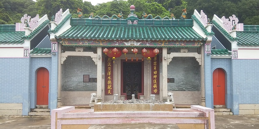 Tin Hau Temple at Joss House Bay with scriptures on the entrance and multiple lamps hanging, one of the popular temples in Hong Kong.