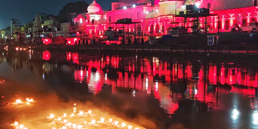 Soft glow from hundreds of diyas lining the riverbank steps in Ayodhya at dusk.