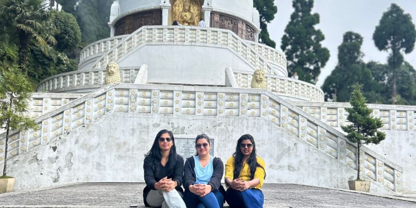 A group of friends posing in front of the revered Peace Pagoda, Darjeeling.
