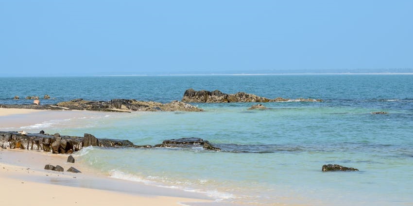 Scenic view of Uppinakudru Island with waves crashing over rocks.