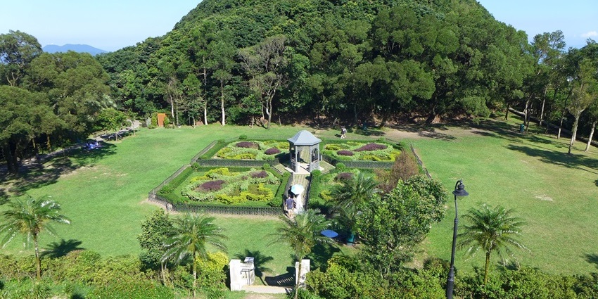 Elevated view of gazebo, lawns, and flowers at Victoria Peak Garden, one of the iconic parks in Hong Kong.
