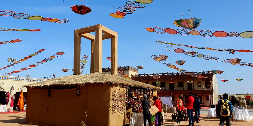 Visitors exploring traditional handicraft villages, watching artisans at work.