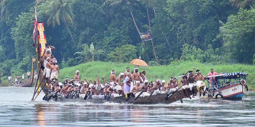 A group of men row their long snake boat on the Pampa River during a boat race in Kerala.
