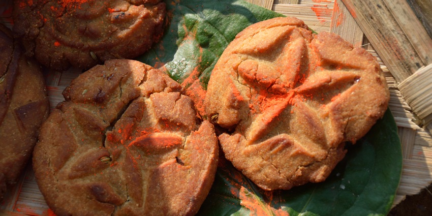 Freshly prepared thekua, a traditional dish kept in sunlight on a big green leaf.
