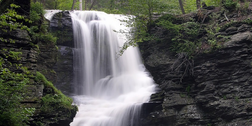 Whisper Wave Waterfall cascading through dense forest, one of the beautiful waterfalls in Andaman.
