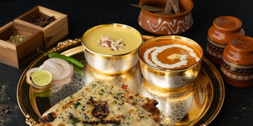 Traditional Indian thali with dal and naan served at Yellow Chilli restaurant.