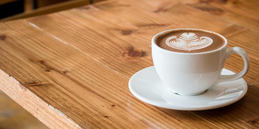 A cup of cappuccino with latte art served at 11th Avenue Bistro, one of the top cafes in Uzan Bazar Guwahati.