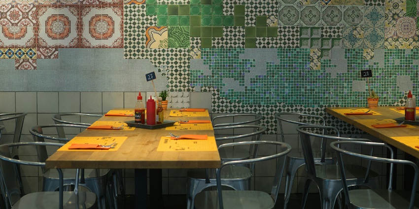 Casual dining setup with tiled wall, wooden tables, and chairs, one of the restaurants in Aizawl.