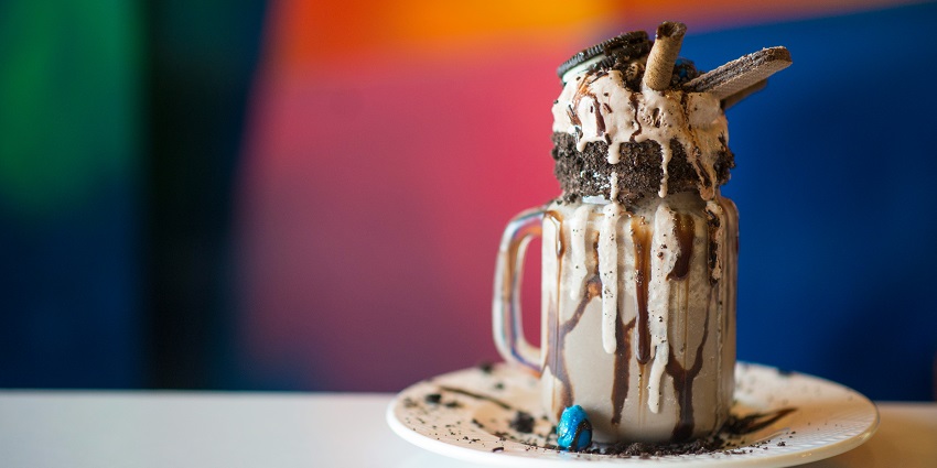 Chocolate milkshake with ice cream on top served in a glass at the Addicted café.
