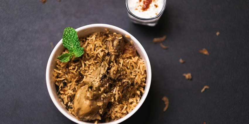 Chicken biryani served with raita at Aminia Restaurant, one of the top restaurants in Paltan Bazar Guwahati.
