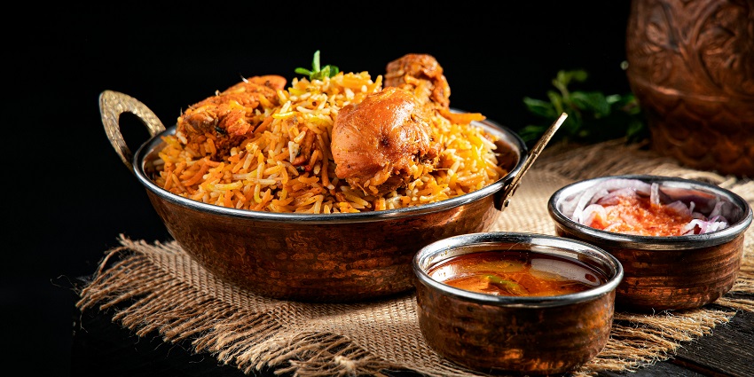 Chicken biryani served with raita at Biryani By Kilo, a top pick among restaurants in Ulubari Guwahati.