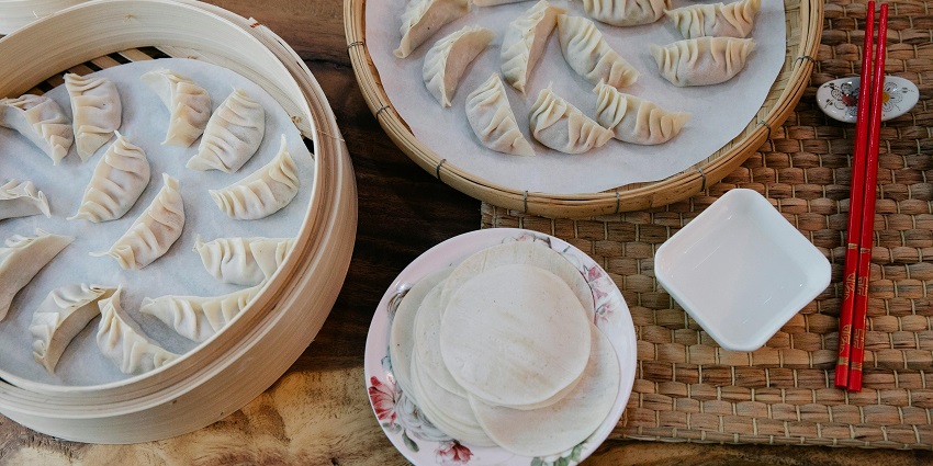 Steamed momos served in a wooden box at Cafe Shillong.
