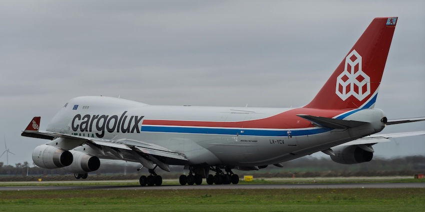 Cargolux Boeing 747 cargo aircraft taking off from a runway under cloudy grey skies in airports in Tripura.
