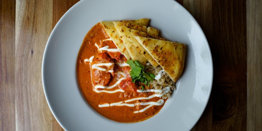 Butter chicken with a side of flatbread served at Daddy Rooftop Restaurant.