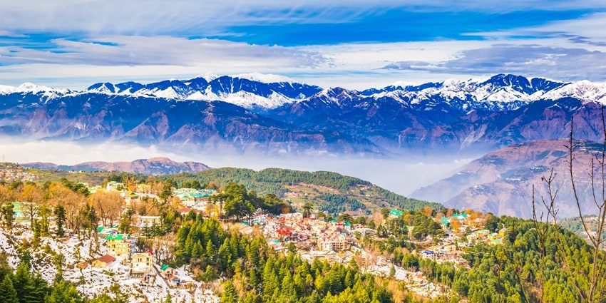 A breathtaking aerial view of Dalhousie with snow-covered peaks in the backdrop.
