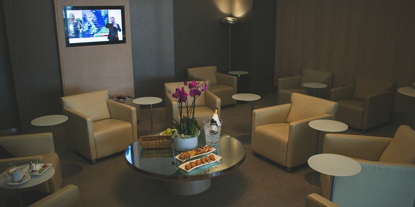 Spacious airport lounge with modern chairs and a glass table, one of the airports in Kashmir.
