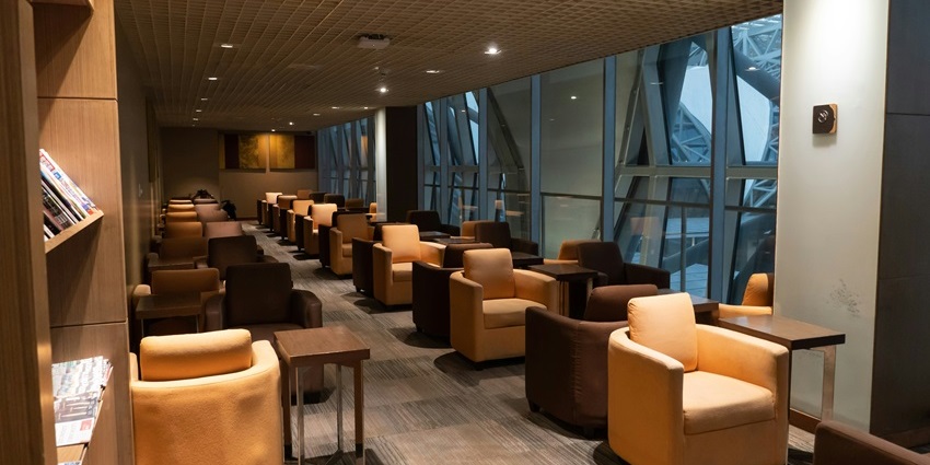Indoor lounge area with a relaxing couch and a side table at Leh Airport, one of the airports in Ladakh.