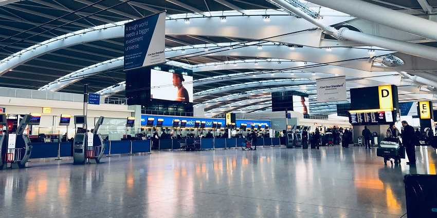 Departure area of a Kashmir airport with check-in counters and modern interiors.
