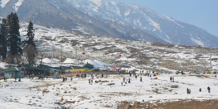 Stunning winter landscape of Gulmarg, Kashmir, featuring snow-blanketed fields, majestic pine trees