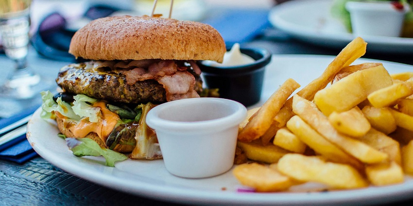 Burger and fries with dipping sauce served at Guwahati Social Cafe, one of the top cafes in Zoo Road Guwahati.
