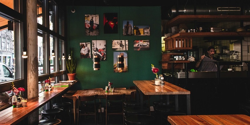 Himalayan Java Coffee interior with a brown wooden dining table and decor, one of the famous cafes in Darjeeling.