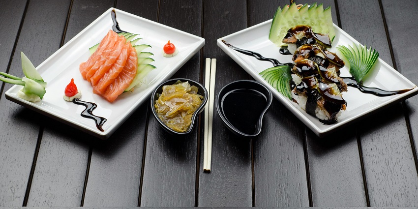 Fresh salmon sashimi and sushi rolls with soy sauce and garnish, one of the popular restaurants in Aizawl.