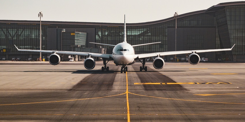 Airplane on the runway at Jammu Airport ready for takeoff with clear surroundings.
