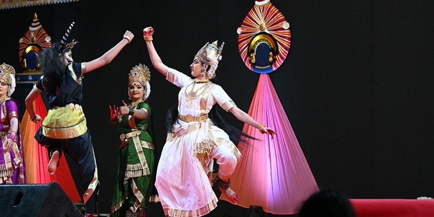 Traditional dancers in vibrant costumes performing on stage—Manipur Sangai Festival