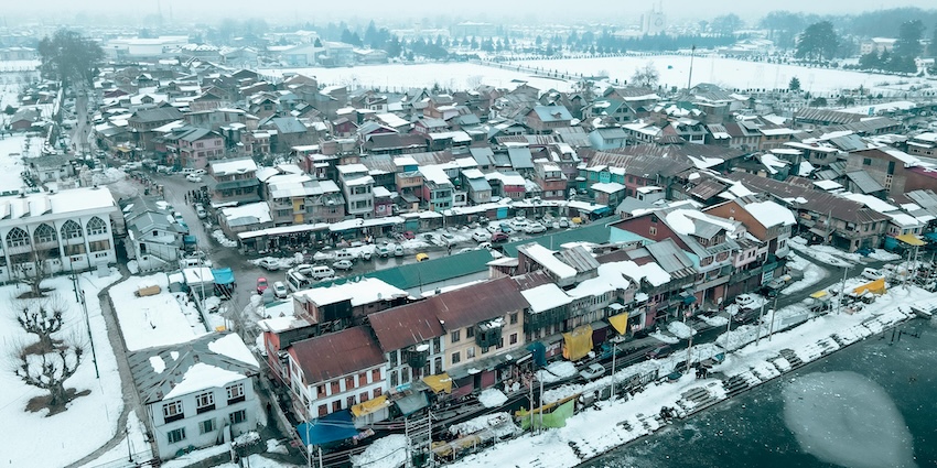Houses and buildings of Srinagar from above with roads and pathways, showing snowfall in Srinagar.