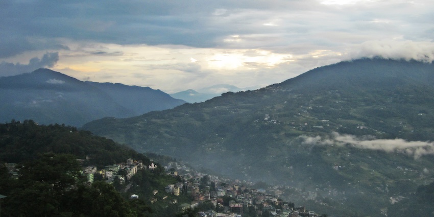 A panoramic view of Gangtok city surrounded by lush green hills snowfall in Gangtok.