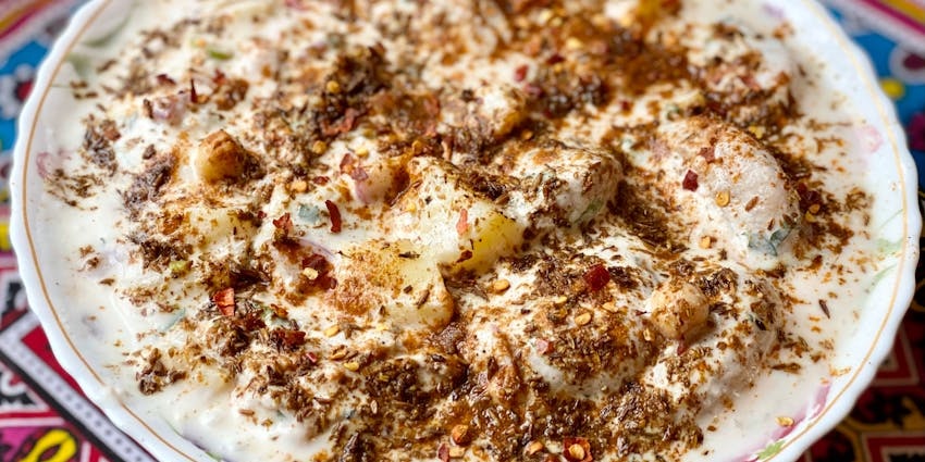 Dahi vada served on a plate at Makhan Bhog restaurant.