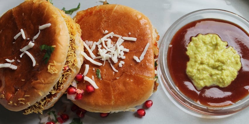 Dabeli served on a white plate with chutney at Makhan Bhog.