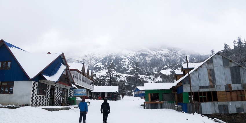 Thick blankets of snow covering the town and cottages of Manali, and the milky sky.