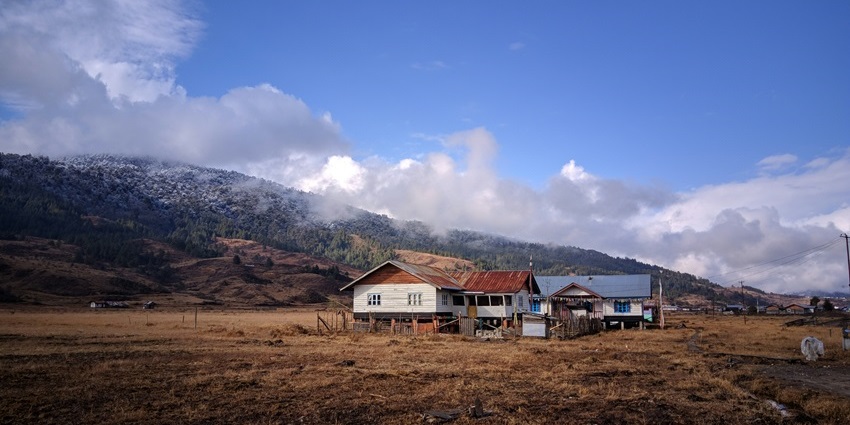 A quaint view of Mechuka, a village elegantly nestled on the sprawling, lush grounds.